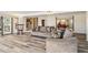 Bright living room with water view, wood floors, modern lighting, and comfortable sofas for relaxing and entertaining at 3708 Plumosa Ter, Bradenton, FL 34210