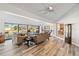 Open living room with wood floors and water views through sliding glass doors to combine indoor and outdoor spaces at 3708 Plumosa Ter, Bradenton, FL 34210