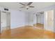 Spacious bedroom featuring a ceiling fan, mirrored closet doors, and tiled entryway to an ensuite bathroom at 3908 Panola Ln # 193, Sarasota, FL 34232