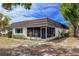This is an exterior angle of the home, with a screen room and some front yard greenery at 3908 Panola Ln # 193, Sarasota, FL 34232
