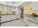Functional kitchen with white cabinetry, green countertops, updated appliances, and convenient layout for cooking at 3908 Panola Ln # 193, Sarasota, FL 34232