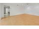 Spacious living room with light wood floors and view into kitchen at 3908 Panola Ln # 193, Sarasota, FL 34232