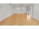 Open living room with light wood floors and sliding glass doors to enclosed porch at 3908 Panola Ln # 193, Sarasota, FL 34232