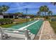 Outdoor shuffleboard court with benches, palm trees, and well-maintained landscaping for community recreation at 3908 Panola Ln # 193, Sarasota, FL 34232