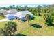 Aerial view of the home and surrounding neighborhood with lush landscaping at 3910 Cape Haze Dr, Rotonda West, FL 33947