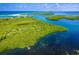 Stunning aerial showcasing lush greenery, sandy beaches, and inviting blue waters at 3910 Cape Haze Dr, Rotonda West, FL 33947