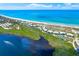 An aerial view features a lakeside residential community near a stunning beach at 3910 Cape Haze Dr, Rotonda West, FL 33947