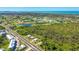 Scenic aerial view highlighting the property's proximity to a golf course and a large wooded area at 3910 Cape Haze Dr, Rotonda West, FL 33947
