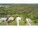 An aerial view showcasing a well-kept lawn surrounding a charming light-blue single-story house at 3910 Cape Haze Dr, Rotonda West, FL 33947