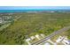Aerial view highlighting proximity to a main road and surrounding natural landscapes in a tranquil setting at 3910 Cape Haze Dr, Rotonda West, FL 33947