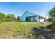 Spacious backyard with mature trees and a screened-in patio area at 3910 Cape Haze Dr, Rotonda West, FL 33947