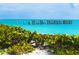 Picturesque view of the beach and the pier remains on the ocean with beach foliage at 3910 Cape Haze Dr, Rotonda West, FL 33947