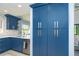 Bright kitchen features custom blue cabinetry with brushed silver hardware and stainless steel appliances at 3910 Cape Haze Dr, Rotonda West, FL 33947