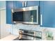 Modern stainless steel microwave and range with herringbone backsplash and white countertops at 3910 Cape Haze Dr, Rotonda West, FL 33947