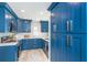 Modern kitchen with blue cabinets, stainless steel appliances, and ample countertop space at 3910 Cape Haze Dr, Rotonda West, FL 33947
