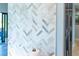 Close up of the white and gray herringbone backsplash in the kitchen and access to the outdoors at 3910 Cape Haze Dr, Rotonda West, FL 33947