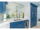This open-concept kitchen has white countertops, blue cabinets, and a seamless transition to an outdoor dining area at 3910 Cape Haze Dr, Rotonda West, FL 33947