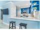 Kitchen bar area with seating, custom cabinetry, herringbone backsplash, and stainless steel appliances at 3910 Cape Haze Dr, Rotonda West, FL 33947