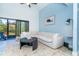 Comfortable living room featuring a large sofa, round coffee table, and a view of the screened-in patio at 3910 Cape Haze Dr, Rotonda West, FL 33947