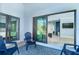 Outdoor patio with sliding glass doors, seating, and a decorative blue rug at 3910 Cape Haze Dr, Rotonda West, FL 33947