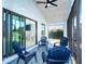 Relaxing screened patio with ceiling fan and multiple chairs with views of the backyard at 3910 Cape Haze Dr, Rotonda West, FL 33947
