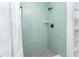Modern shower with seafoam-colored tiles and herringbone flooring detail at 3910 Cape Haze Dr, Rotonda West, FL 33947