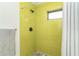Shower with bright yellow subway tile and neutral shower curtain at 3910 Cape Haze Dr, Rotonda West, FL 33947