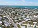 Wide aerial shot of a residential neighborhood, featuring streets, homes, trees, and waterfront views in the distance at 402 71St St, Holmes Beach, FL 34217