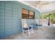Relaxing back porch features comfortable seating, ceiling fan, and a view of the outdoor pool at 402 71St St, Holmes Beach, FL 34217