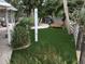 Lush backyard featuring green grass, patio, lounge chair, tropical foliage, and an outdoor shower at 402 71St St, Holmes Beach, FL 34217