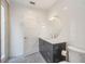 Elegant bathroom with sleek vanity, decorative mirror, and patterned tile floor at 402 71St St, Holmes Beach, FL 34217