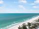 Aerial shot of a pristine beach and turquoise ocean, with residential buildings along the shoreline at 402 71St St, Holmes Beach, FL 34217