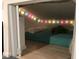 A cozy hideaway bedroom nook with colorful string lights and a plush crocodile at 402 71St St, Holmes Beach, FL 34217