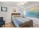 Comfortable bedroom featuring a wood framed bed, with bright wall art and natural light at 402 71St St, Holmes Beach, FL 34217