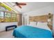 Bright bedroom features a large window, blue bedding, and modern decor at 402 71St St, Holmes Beach, FL 34217