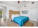 Cozy bedroom with a queen bed, neutral tones, and private access to outdoor space at 402 71St St, Holmes Beach, FL 34217