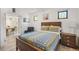 Cozy bedroom with wood framed bed, colorful quilt, and view of the dining room at 402 71St St, Holmes Beach, FL 34217