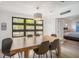 Dining room featuring wood table, modern chandelier and a view of the bedroom at 402 71St St, Holmes Beach, FL 34217