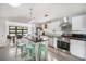 Bright kitchen with modern appliances, white cabinets, granite countertops and a large island with seating at 402 71St St, Holmes Beach, FL 34217