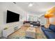 Spacious open living room with modern lighting, stylish furniture, and bright decor at 402 71St St, Holmes Beach, FL 34217