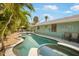 A beautiful outdoor pool and patio area is framed by lush tropical landscaping at 402 71St St, Holmes Beach, FL 34217