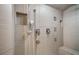 This large shower has a built-in shelf and bench with multiple water features at 402 71St St, Holmes Beach, FL 34217