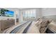 Inviting bedroom showcasing a stylish beach theme, shuttered windows, and balcony view at 4305 Marina View Way, Cortez, FL 34215