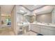 Bright bathroom with dual sinks, a vanity area, and a sky light for natural light at 4420 Oak View Dr, Sarasota, FL 34232
