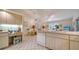 Bright kitchen with tiled floors, modern appliances, and adjacent eat-in area with a view of the lanai at 4420 Oak View Dr, Sarasota, FL 34232