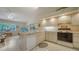 Bright kitchen with tiled floors, modern appliances, and adjacent eat-in area with a view of the lanai at 4420 Oak View Dr, Sarasota, FL 34232
