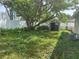 View of expansive backyard with included storage shed, landscaping and fencing at 4431 W Wallace Ave, Tampa, FL 33611