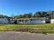 Charming single-story home with a covered carport and well-maintained front lawn at 4431 W Wallace Ave, Tampa, FL 33611