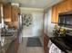 Charming kitchen features granite countertops, stainless steel appliances, and beautiful wooden cabinetry at 4431 W Wallace Ave, Tampa, FL 33611