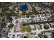 Aerial view of a community with a lake, tree-lined streets and private pools at 4662 Long Lake Dr, Sarasota, FL 34233